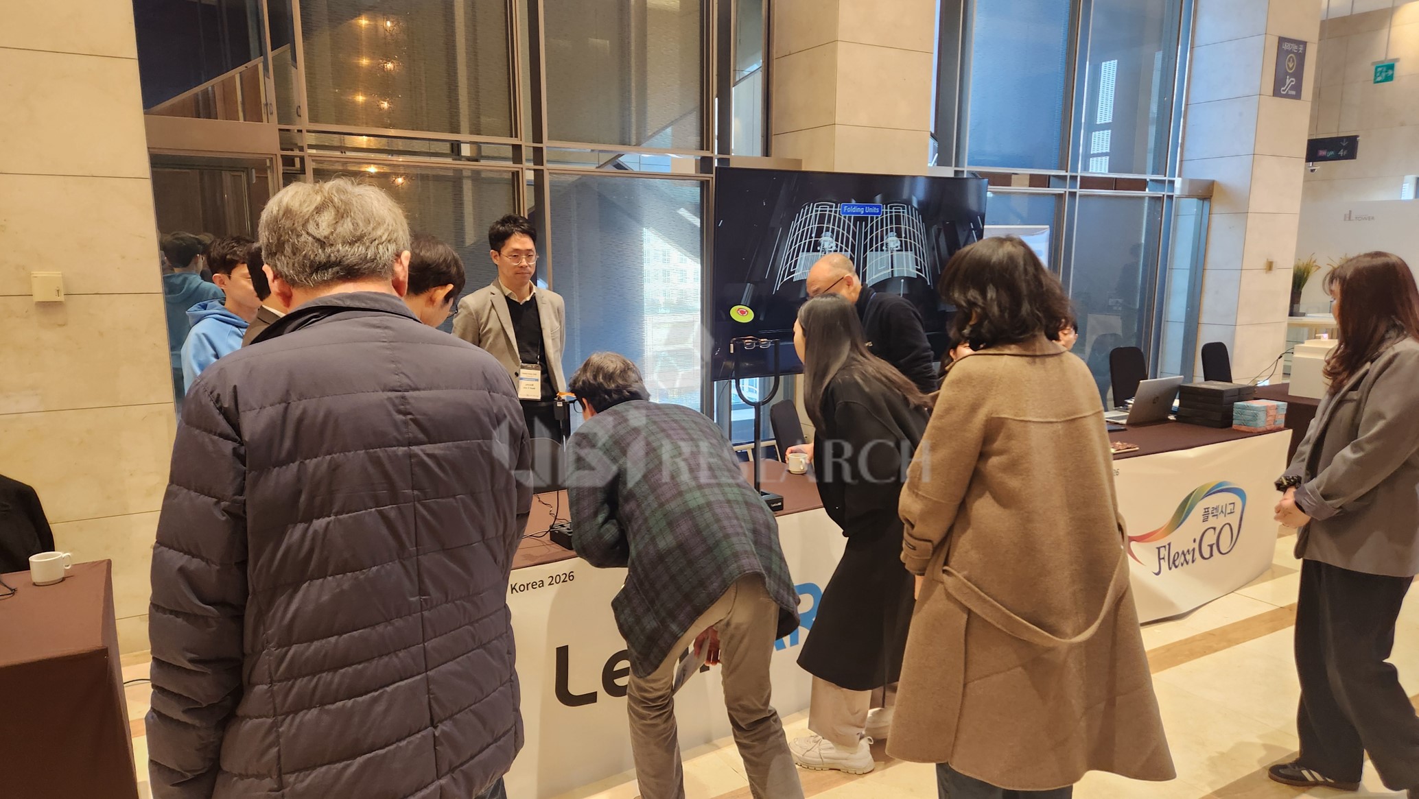 Visitors experiencing AR glasses based on PinTILT optical technology at the LetinAR booth