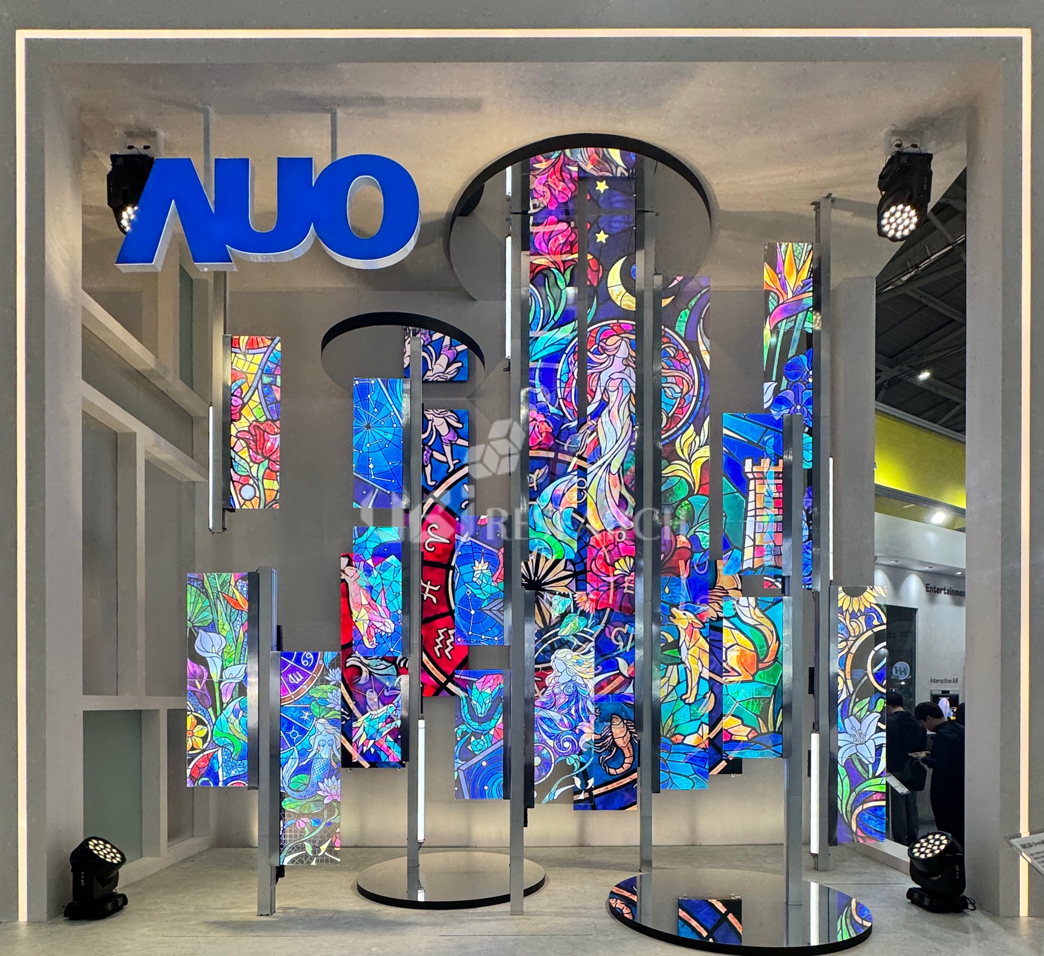 Giant transparent Micro-LED display structure featuring a colorful stained glass pattern at the entrance of the AUO booth at Touch Taiwan 2026